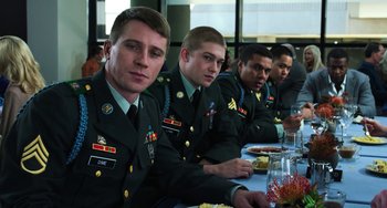 Movie still from “Billy Lynn's Long Halftime Walk” (2016), directed by Ang Lee – A group of men sitting at a table with food; Medium shot, Over the shoulder angle