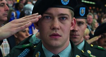 Movie still from “Billy Lynn's Long Halftime Walk” (2016), directed by Ang Lee – A man saluting in front of a group of people; Close Up shot, Low angle