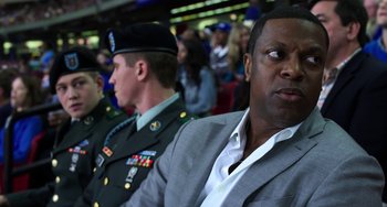Movie still from “Billy Lynn's Long Halftime Walk” (2016), directed by Ang Lee – A man in a military uniform sitting next to another man in a suit; Close Up shot, Over the shoulder angle