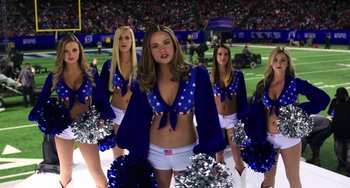 Movie still from “Billy Lynn's Long Halftime Walk” (2016), directed by Ang Lee – A group of cheerleaders are standing in a field; Medium shot, Low angle