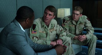Movie still from “Billy Lynn's Long Halftime Walk” (2016), directed by Ang Lee – A group of men sitting next to each other in a room; Medium shot, Over the shoulder angle