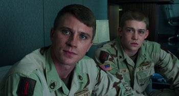 Movie still from “Billy Lynn's Long Halftime Walk” (2016), directed by Ang Lee – Two men in military fatigues sitting next to each other; Close Up shot, Low angle