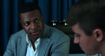Movie still from “Billy Lynn's Long Halftime Walk” (2016), directed by Ang Lee – A man in a gray suit is looking at another man in a white shirt; Close Up shot, Over the shoulder angle