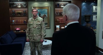 Movie still from “Billy Lynn's Long Halftime Walk” (2016), directed by Ang Lee – A man in a military uniform standing in front of an older man; Medium shot, Over the shoulder angle