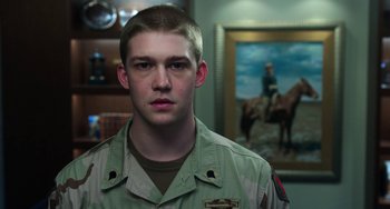 Movie still from “Billy Lynn's Long Halftime Walk” (2016), directed by Ang Lee – A man in a uniform standing in front of a painting; Close Up shot, Over the shoulder angle