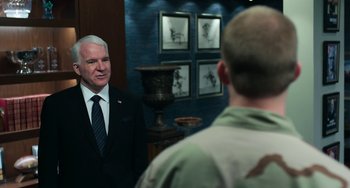 Movie still from “Billy Lynn's Long Halftime Walk” (2016), directed by Ang Lee – A man standing in front of a mirror in a suit; Medium shot, Over the shoulder angle