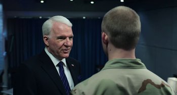 Movie still from “Billy Lynn's Long Halftime Walk” (2016), directed by Ang Lee – A man in a suit and tie talking to another man in a uniform; Close Up shot, Over the shoulder angle
