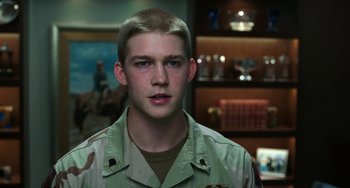 Movie still from “Billy Lynn's Long Halftime Walk” (2016), directed by Ang Lee – A man in a military uniform is looking at the camera; Close Up shot, Low angle