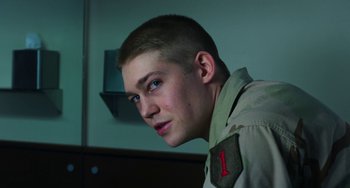 Movie still from “Billy Lynn's Long Halftime Walk” (2016), directed by Ang Lee – A young man with short hair wearing a military uniform; Close Up shot, Low angle