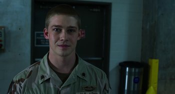 Movie still from “Billy Lynn's Long Halftime Walk” (2016), directed by Ang Lee – A man in a military uniform standing in a room; Close Up shot, Over the shoulder angle