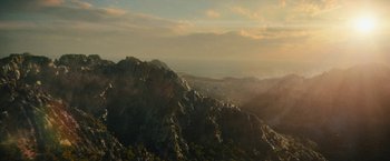 Movie still from “Black Adam” (2022), directed by Jaume Collet-Serra – A view of a mountain range from a distance at sunset; Extreme Wide shot, High angle