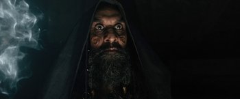 Movie still from “Black Adam” (2022), directed by Jaume Collet-Serra – A man with a long beard and a black hooded cape; Close Up shot, Low angle
