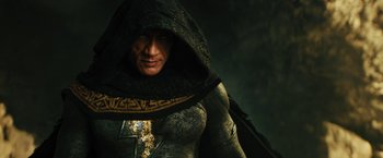 Movie still from “Black Adam” (2022), directed by Jaume Collet-Serra – A person with a hood on; Medium shot, High angle