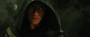 Movie still from “Black Adam” (2022), directed by Jaume Collet-Serra – A person wearing a hooded jacket; Close Up shot, Low angle