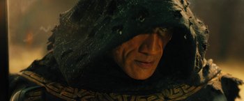 Movie still from “Black Adam” (2022), directed by Jaume Collet-Serra – A man wearing a hood is looking at the camera; Close Up shot, Low angle