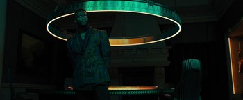 Movie still from “Black Adam” (2022), directed by Jaume Collet-Serra – A man standing in front of a neon sign; Medium shot, Low angle