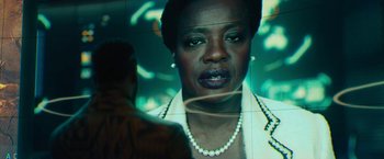 Movie still from “Black Adam” (2022), directed by Jaume Collet-Serra – A black woman with a pearl necklace is reflected in a mirror; Close Up shot, Over the shoulder angle
