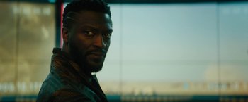 Movie still from “Black Adam” (2022), directed by Jaume Collet-Serra – A man's face in front of a window; Close Up shot, Over the shoulder angle