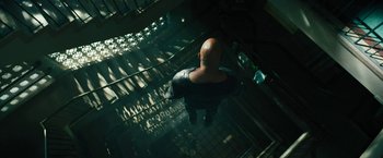 Movie still from “Black Adam” (2022), directed by Jaume Collet-Serra – A man standing on top of a set of stairs; Wide shot, Overhead angle