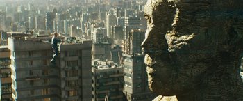 Movie still from “Black Adam” (2022), directed by Jaume Collet-Serra – A statue of a man's face in the middle of a city; Extreme Close Up shot, Low angle