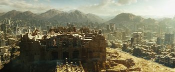 Movie still from “Black Adam” (2022), directed by Jaume Collet-Serra – An aerial view of a city with a castle in the foreground; Extreme Wide shot, High angle