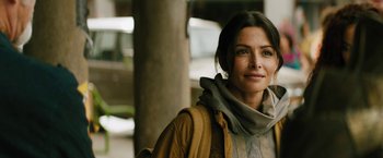 Movie still from “Black Adam” (2022), directed by Jaume Collet-Serra – A woman in a brown jacket and a scarf; Close Up shot, Over the shoulder angle