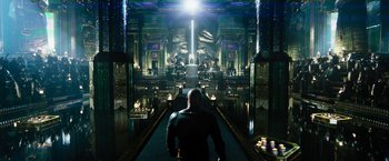 Movie still from “Black Adam” (2022), directed by Jaume Collet-Serra – A man is walking down a hallway in a building; Extreme Wide shot, High angle