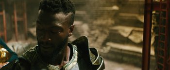 Movie still from “Black Adam” (2022), directed by Jaume Collet-Serra – A person wearing a jacket; Close Up shot, Over the shoulder angle