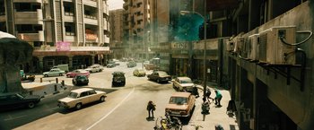 Movie still from “Black Adam” (2022), directed by Jaume Collet-Serra – A street scene with cars and people on the side of the road; Extreme Wide shot, High angle