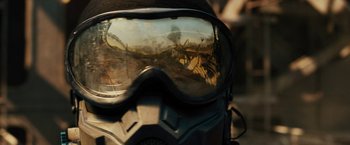 Movie still from “Black Adam” (2022), directed by Jaume Collet-Serra – The reflection of a person in a helmet; Extreme Close Up shot, Over the shoulder angle
