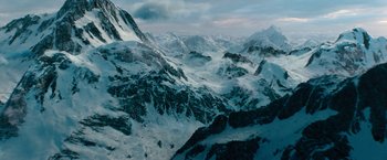Movie still from “Black Adam” (2022), directed by Jaume Collet-Serra – A view of a mountain range from a helicopter; Extreme Wide shot, High angle