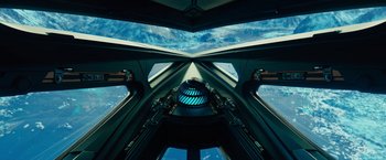 Movie still from “Black Adam” (2022), directed by Jaume Collet-Serra – Looking up at the view from inside a space ship; Extreme Wide shot, Overhead angle