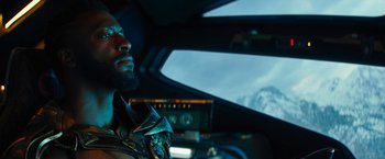 Movie still from “Black Adam” (2022), directed by Jaume Collet-Serra – A person sitting in a vehicle; Close Up shot, Low angle