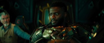 Movie still from “Black Adam” (2022), directed by Jaume Collet-Serra – A person holding a bunch of money; Close Up shot, Low angle