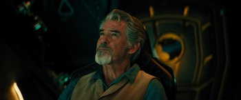 Movie still from “Black Adam” (2022), directed by Jaume Collet-Serra – An older man sitting in a chair looking up at the sky; Close Up shot, Over the shoulder angle