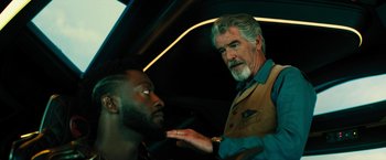 Movie still from “Black Adam” (2022), directed by Jaume Collet-Serra – A man talking to another man inside a car; Close Up shot, Over the shoulder angle