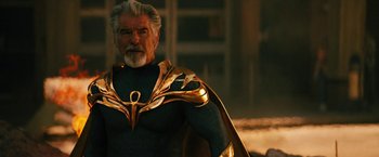 Movie still from “Black Adam” (2022), directed by Jaume Collet-Serra – An older man with a beard wearing a gold and black costume; Medium shot, Low angle