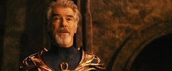 Movie still from “Black Adam” (2022), directed by Jaume Collet-Serra – An older man with white hair and a beard wearing a gold and black outfit; Close Up shot, Low angle