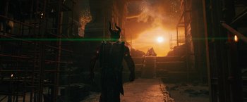 Movie still from “Black Adam” (2022), directed by Jaume Collet-Serra – A man with a horned helmet standing in front of an entrance to a building; Wide shot, High angle