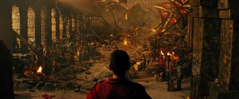 Movie still from “Black Adam” (2022), directed by Jaume Collet-Serra – A crowd of people standing around a building; Extreme Wide shot, High angle