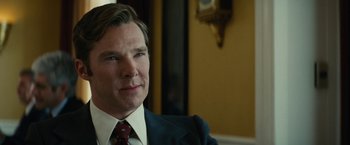 Movie still from “Black Mass” (2015), directed by Scott Cooper – A person wearing a suit and tie; Close Up shot, Over the shoulder angle