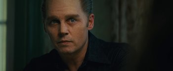 Movie still from “Black Mass” (2015), directed by Scott Cooper – A person wearing a black shirt; Close Up shot, Low angle