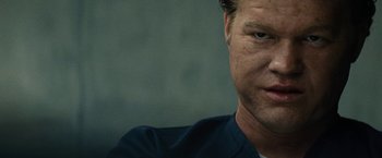 Movie still from “Black Mass” (2015), directed by Scott Cooper – A man's face in a dark room; Close Up shot, Low angle