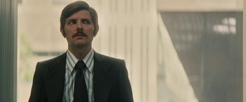 Movie still from “Black Mass” (2015), directed by Scott Cooper – A man in a suit and tie looking up; Close Up shot, Low angle