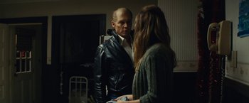 Movie still from “Black Mass” (2015), directed by Scott Cooper – A man and a woman are talking in front of a mirror; Medium shot, Over the shoulder angle