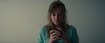 Movie still from “Black Mass” (2015), directed by Scott Cooper – A woman holding a coffee cup in her hands; Close Up shot, Over the shoulder angle