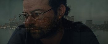 Movie still from “Black Mass” (2015), directed by Scott Cooper – A man's face with buildings in the background; Extreme Close Up shot, Over the shoulder angle