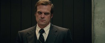 Movie still from “Black Mass” (2015), directed by Scott Cooper – A person wearing a suit and tie; Close Up shot, Low angle