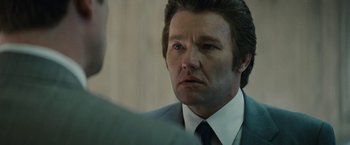 Movie still from “Black Mass” (2015), directed by Scott Cooper – A person wearing a suit and tie; Close Up shot, Over the shoulder angle