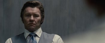 Movie still from “Black Mass” (2015), directed by Scott Cooper – A person wearing a suit and tie; Close Up shot, Low angle